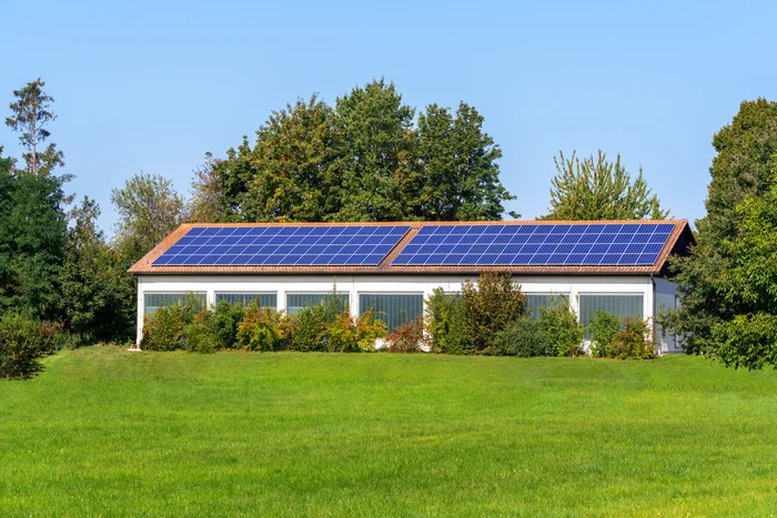 Solar system on the roof of a house on the grass